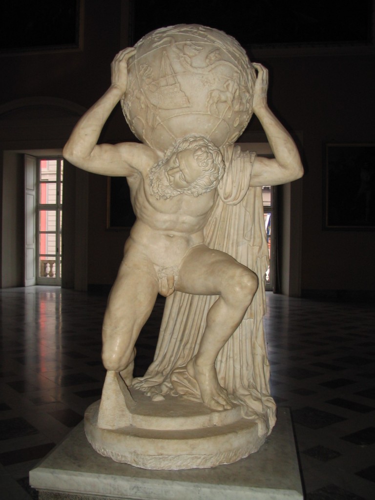 Photo of the Farnese Atlas sculpture. The sculpture is light marble; the room it's in is dark and there are two windows behind it. 
