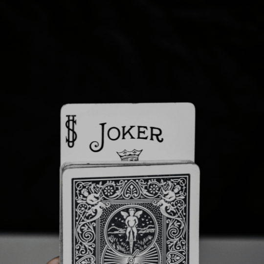 Close-up of Joker card in a standard deck; Photo by Klim Musalimov (Unsplash)